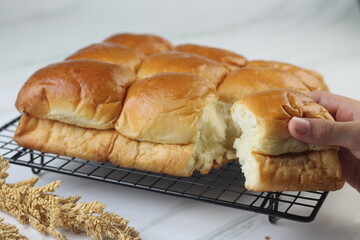 Roti Sobek or Pull Out Soft bread on black cooling rack. Isolated white background.