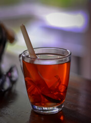 a glass of tea on a wooden table