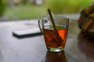 a glass of tea on a wooden table