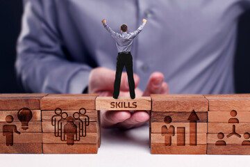 Business, Technology, Internet and network concept. Young businessman shows the word:Skills