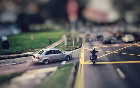 Tilt-shift Image Of Car And Motorcycle On Road In City