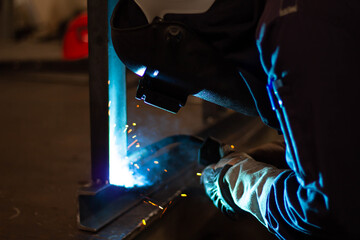 Metal workers use manual labor, Skilled welder, Factory workers making OT. Welder is welding the...