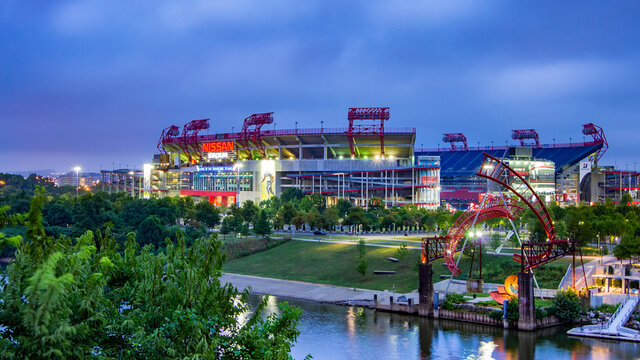 Nashville, TN--July 31, 2018; riverside view of Nissan Stadium home to Tennessee Titans NFL football team at sunrise with overcast sky