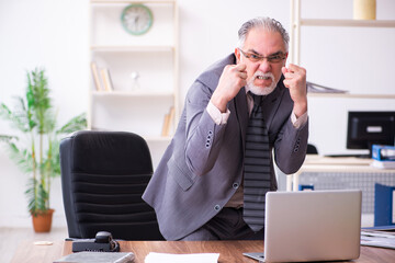 Businessman angry and furious at the workplace