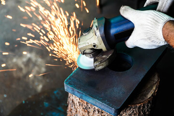 Electric iron grinding machine in factory Sparks from grinding wheels
