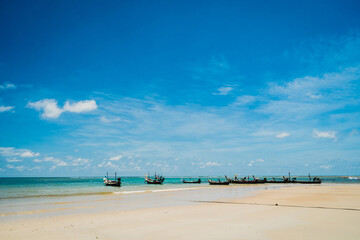 Tropical nature clean beach and white sand in summer with sun light blue sky background.