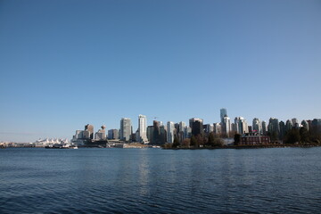 View of Vancouver downtown skyline and coal harbour seen from Vancouver Stanley Park, British Columbia,  Canada.