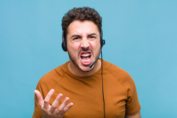 young man looking angry, annoyed and frustrated screaming wtf or what’s wrong with you