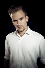 Obraz premium Young man dressed in white shirt studio portrait