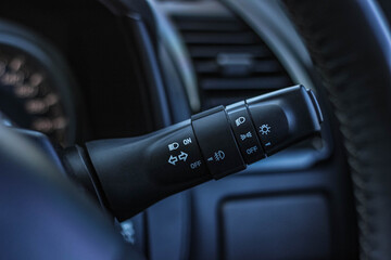 Switch off lights in a car. close-up Car integrated turning indicator with headlight switch toggle.