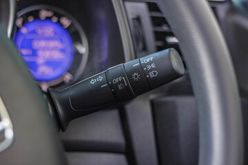 Switch off lights in a car. close-up Car integrated turning indicator with headlight switch toggle.