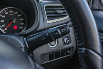 Fototapeta premium Switch off lights in a car. close-up Car integrated turning indicator with headlight switch toggle.