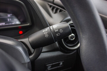 Plakat Switch off lights in a car. close-up Car integrated turning indicator with headlight switch toggle.
