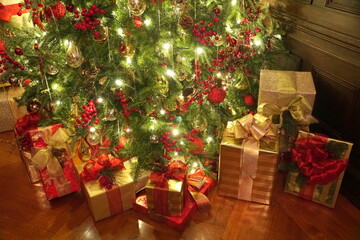 Boxes of gifts under the Christmas tree with lights