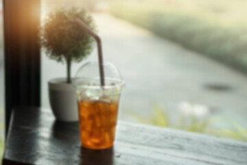 blurred Ice lemon tea in cups on a wooden table in a coffee shop