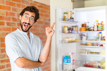 bearded man feeling like a happy and excited genius after realizing an idea, cheerfully raising...