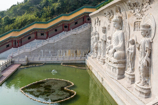 Buddha statue in Chinese traditional royal style Baotuo lecture temple in Putuoshan mountains, Zhoushan Islands,  a renowned site in Chinese bodhimanda of the Guanyin