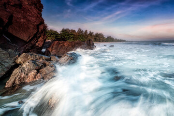 A scenic beauty of splashing wave over coastal rock at  Batu Layar beach, Kota Tinggi. Johore