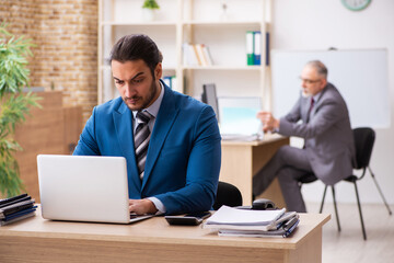Two male colleagues working in the office