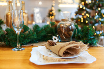 Gala dinner. Cooking at Christmas. New year's interior in the kitchen. Decorations: Christmas tree, garland, cones and glasses, gold and green