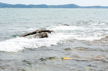 Fototapeta premium sea waves and rock coast, seascape in Thailand