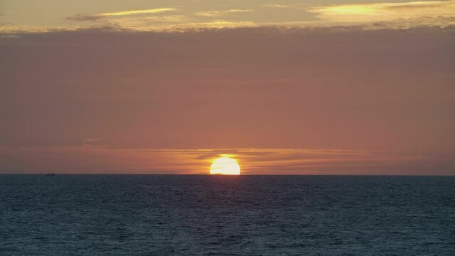 Beautiful sunrise of ocean, great color of the sun. Contrast between the orange of clouds and the blue of the ocean. Shot taken in Imsouane, little village of Morocco