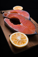 slice of salmon on a board with a cut lemon