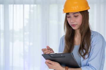 Reconstruction Concept. Chief Engineer Woman In yellow Helmet Standing inside building check the correctness of the construction.