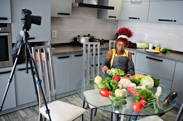 African american woman filming her blog broadcast about healthy food at home kitchen.