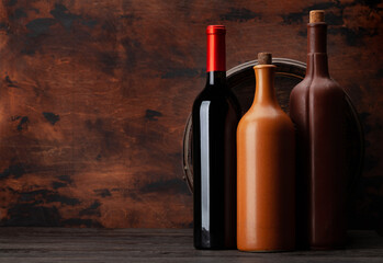 Fototapeta na wymiar Wine bottles and old wooden barrel