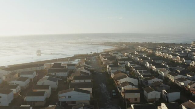 Mediterranean seaside town with beautiful sunrise, early morning. Aerial footage located in Gruissan at the famous beach "Plage des Chalets", 