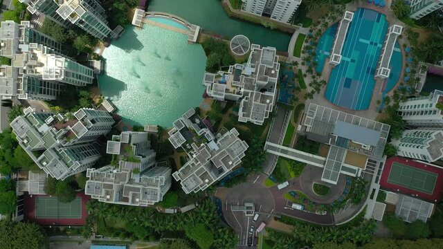 summer day singapore city famous apartment complex swimming pool aerial topdown panorama 4k 