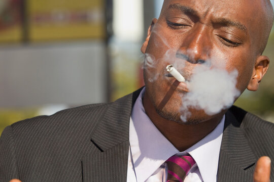 African American businessman smoking cigarette