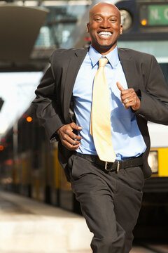 Running African American businessman