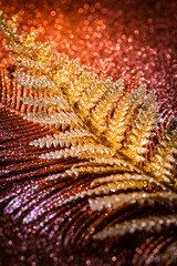 Blurry and abstract Christmas glitter background in red, golden and violet tones