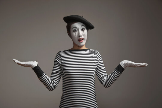 Woman in mime costume with arms outstretched