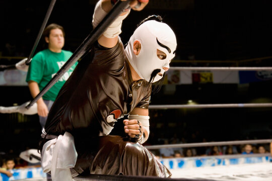 Hispanic man wearing Mexican wrestling costume
