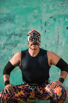 Hispanic man wearing Mexican wrestling costume