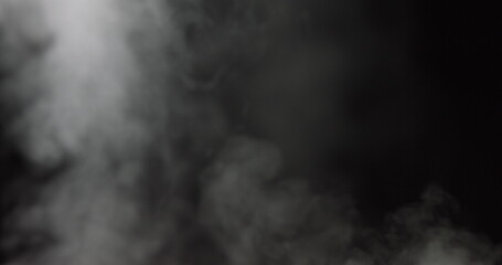Atmospheric smoke VFX overlay element. Haze background. Smoke in slow motion on black background. White smoke slowly floating through space against black background. Mist effect. Fog effect.