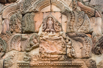 Fototapeta na wymiar Ancient figurines in Prasat Hin Phanom Rung, large, located on a high mountain in the middle of a deep forest built in the ancient Khmer period in Buriram, Thailand.