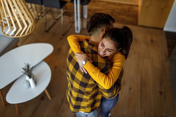 Brunette woman and her man in a hug.