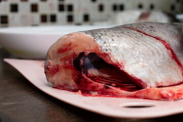headless and peeled fresh trout, drops of blood, fish cooking concept.