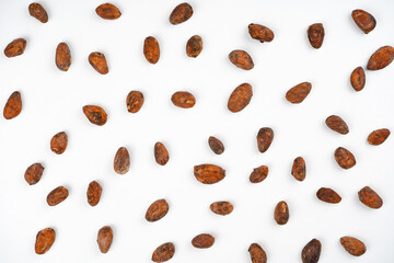 Cocoa bean pattern on white background. Chocolate, dessert, recipe, menu concept. Top view, flat lay, copy space