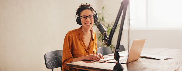 Woman recording podcast at home