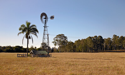 Windmill creating energy to run water pump on rural property