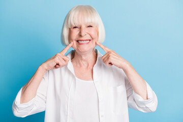 Photo portrait of granny blonde hair pointing at white teeth healthy smile dental whitening veneers...