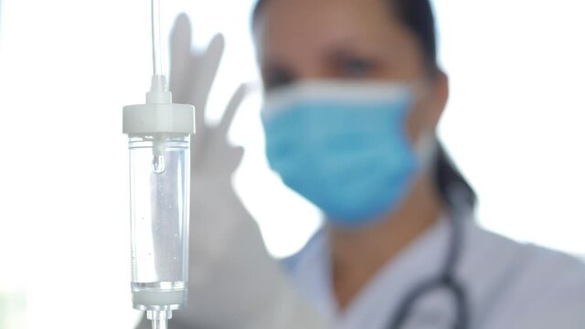 Blurred Image with Doctor Wearing Protective Face Mask and Surgery Gloves Against Coronavirus Infection in Hospital Emergency Room