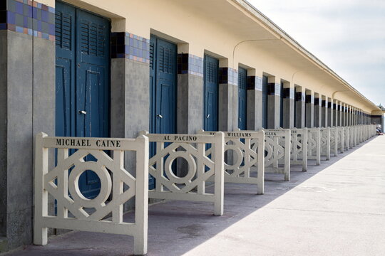 Deauville, France, July 10, 2019. The row of famous beach cabins with celebrity names on promenade des Planches on the seaside.