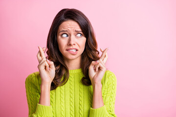Photo of sad charming curly woman dressed green pullover fingers crossed looking empty space...