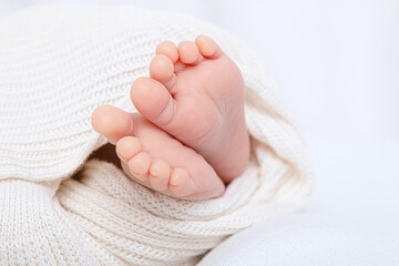 Newbornfeet baby in cotton pants on white background
